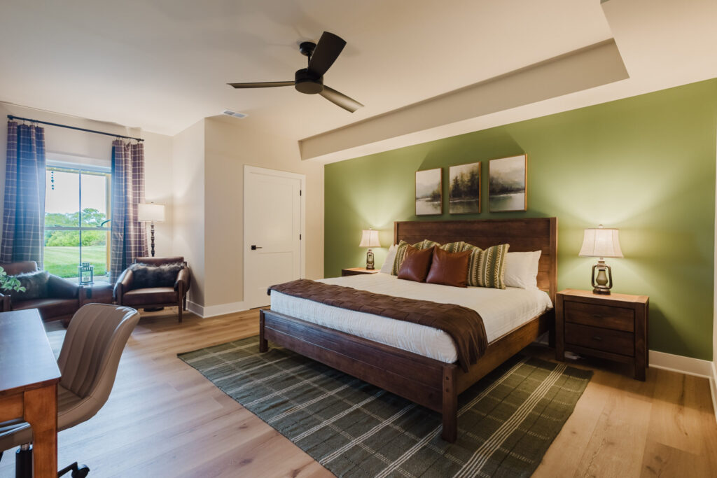 Daniel Boone bedroom with a king bed and green accent wall