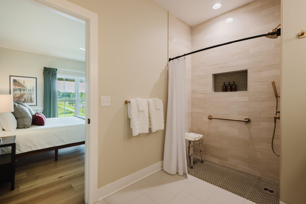 Curbless shower with grab rails in the Kentucky Derby bedroom bathroom