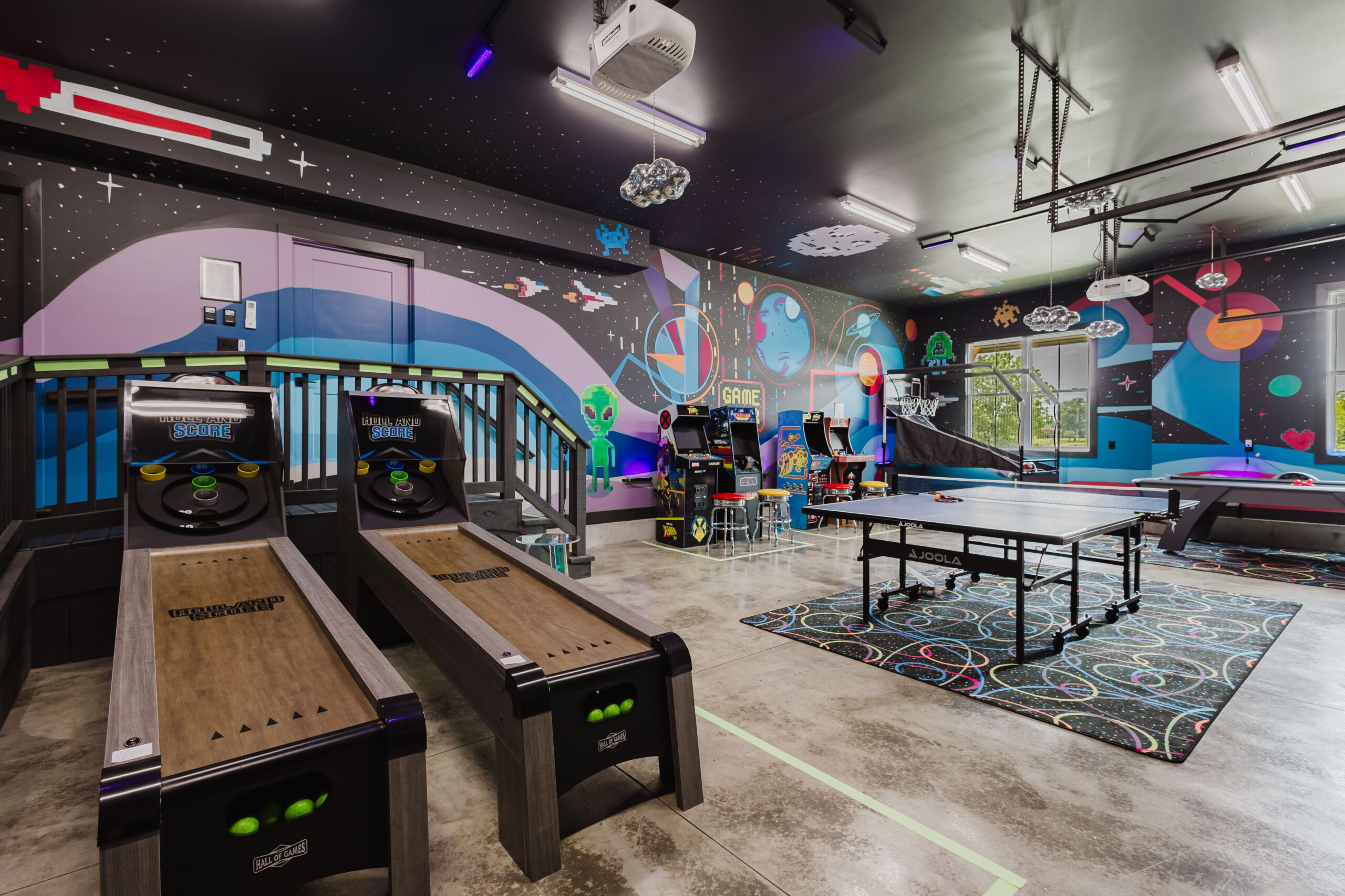 Blacklight arcade with skee-ball and ping-pong at The Lodge